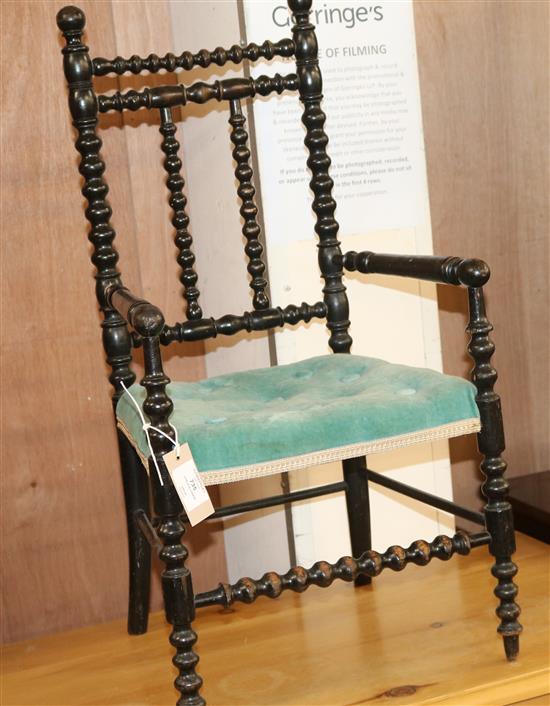 A Victorian childs ebonised bobbin turned elbow chair W.36cm
